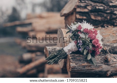 wedding bouquet lies on the logs. soft focus