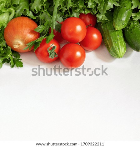 vegetables tomatoes, cucumbers, greens and onions on a white background, close-up, square frame, concept of healthy eating and natural products