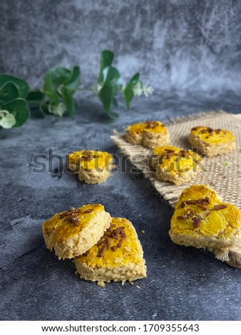 Homemade of coconut cookies or biskut kelapa over dark background. It is most popular during Hari Raya Festival in Malaysia. 