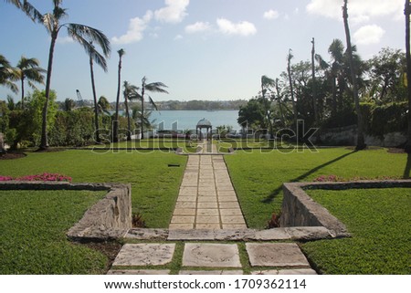 photo of the green meadow with long path to the arch on the caribbean coast