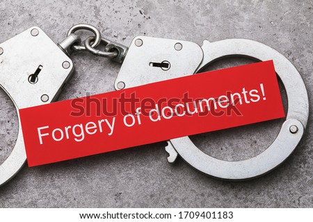 Note with text and handcuffs, top view. The concept of punishment for falsification of documents