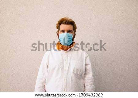 middle adult man in mask white shirt cloth neutral color simple background space for copy or text here, social isolation concept picture 