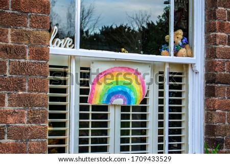 Rainbow drawing in a window- as a sign of hope during the 2020 Coronavirus outbreak (England, UK) Royalty-Free Stock Photo #1709433529