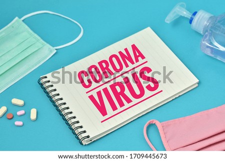 conceptual image of dangerous sars virus, covid-19 coronavirus sign text on small notebook. over blue background.