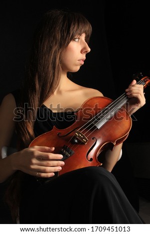 portrait of a pretty woman musician with the violin