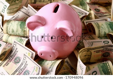 piggy bank on dollars Royalty-Free Stock Photo #170948096