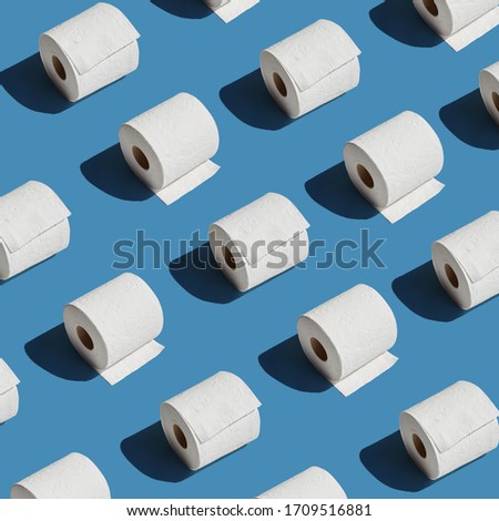 White toilet paper roll on blue background with shadow