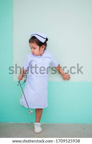 A girl wearing a nursing gown with a stethoscope