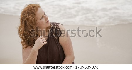 Young woman relaxes on the beach during her summer vacation - travel photography