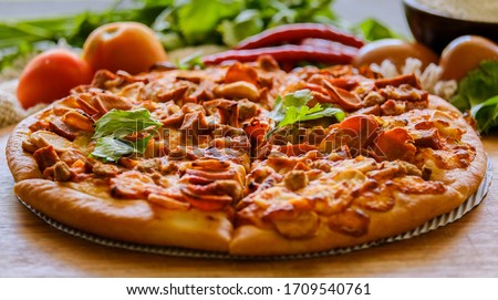 The meat lover pizza is served at Pizza restaurant. Royalty-Free Stock Photo #1709540761