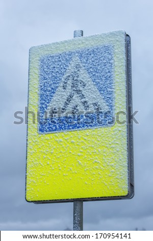 Snowy pedestrian crossing sign 
