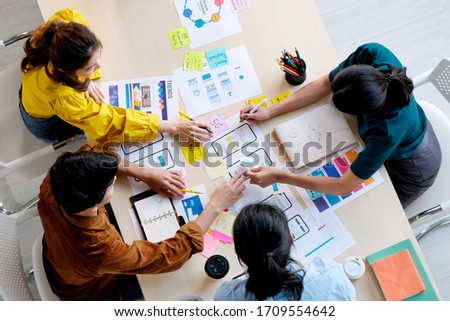Brainstorm planing creative asian teamwork, Group of asia mobile phone app developer team meeting for ideas about screen display prototype smartphone layout, ux startup small business, top view Royalty-Free Stock Photo #1709554642