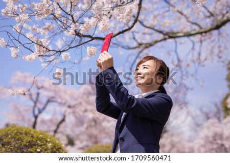 A cherry tree and Asian office worker