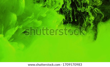 Macro photo shoot of colorful Ink in water. Power magic multi color Underwater Paint Drops background. Red camera still poster backdrop. Beautiful wallpaper.