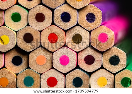 A macro of a very OCD orderly stack of unsharpened colored pencil ends from a mildly oblique angle showing a small segment of the pencil sides.  Sharp and Highly Detailed with a shallow depth of focus