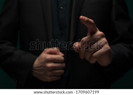 An unidentified young man's hand clicks on an invisible touchpad. Digital and graphic concept. Advertising space. Place for text