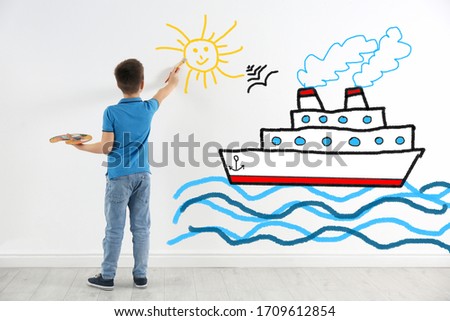 Cute child drawing sea with cruise ship on white wall indoors