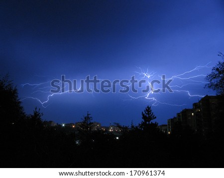 Beautiful powerful lightning over city, zipper and thunderstorm, dark sky with bright electrical flash, thunder and thunderbolt, bad weather concept 