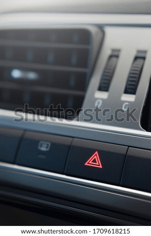 Push button on car dashboard for hazard light