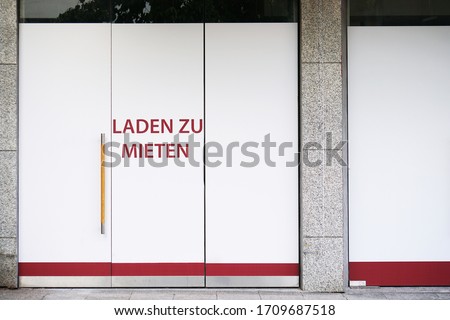 German vacancy sign on storefront - Laden zu mieten translates as store to let