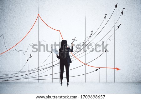 Businesswoman drawing business charts and stock arrow on wall. Success and startup concept.
