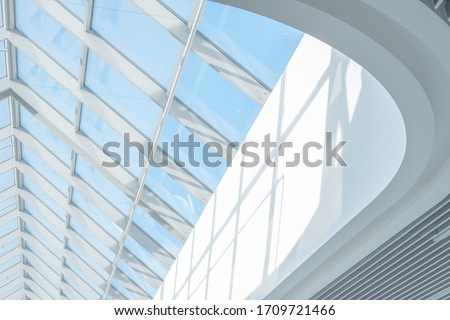 Clean roof windows and blue sky. Element of a modern glass roof of a shopping mall or airport, abstract image Royalty-Free Stock Photo #1709721466