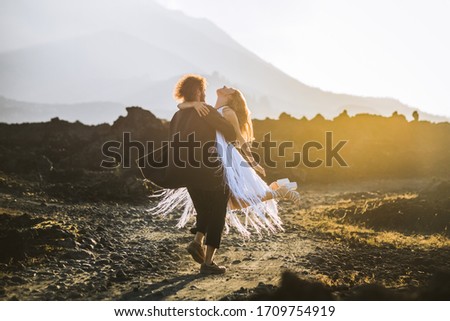 beautiful couple of lovers enjoys life on a background of mountains