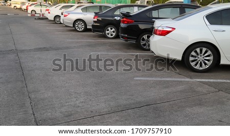 Closeup of rear, back side of white car with  other cars parking in outdoor parking area  in sunny day. Royalty-Free Stock Photo #1709757910