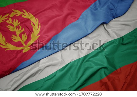 waving colorful flag of bulgaria and national flag of eritrea. macro