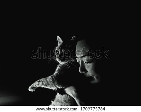 black and white photo woman with a cat
