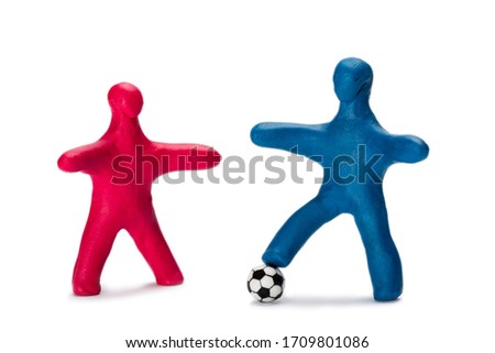 Plasticine small people soccer players with ball isolated on white