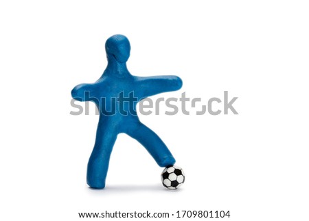 Plasticine small person soccer player with a ball isolated on white