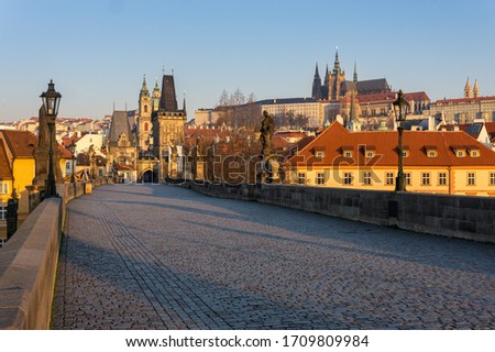 Empty Charles bridge with Prague castle in the background, Prague during sunrise at a time of coronavirus lockdown, Czechia. 