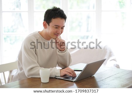 Portrait of an Asian man spending time indoors Royalty-Free Stock Photo #1709837317
