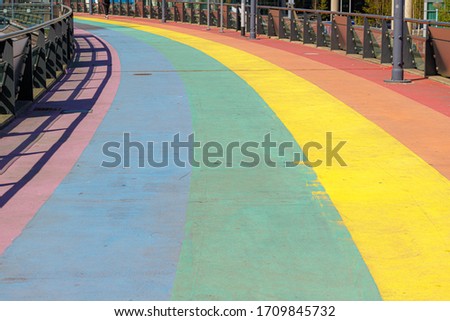 Rainbow pedestrian walkway in city center, Colourful colored pavement in outdoor public, Old and dirty rainbow pathway, The Symbol of gay, Lesbian, Bisexual and transgender, LGBT social movements.
