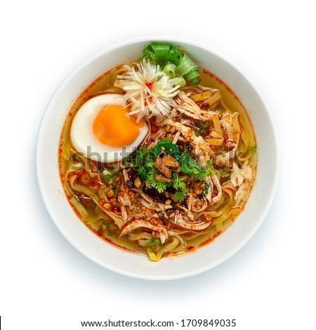 Egg Noodles with Chicken and Boiled Egg in Clear Soup ontop Crispy Garlic,chili oil paste and Corainder Delicious Nomal dish Street Food Asian and Thai Food fusion style decorate vegetables carved 