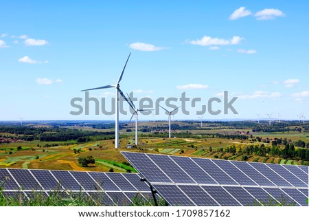 Solar photovoltaic panels and wind turbines. Energy concept Royalty-Free Stock Photo #1709857162