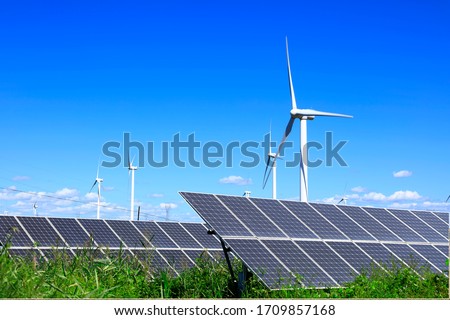 Solar photovoltaic panels and wind turbines. Energy concept Royalty-Free Stock Photo #1709857168