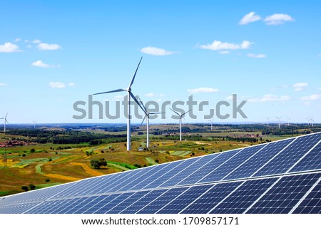 Solar photovoltaic panels and wind turbines. Energy concept Royalty-Free Stock Photo #1709857171