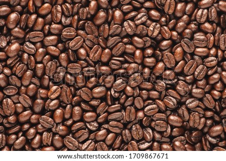 Dark roast coffee beans background, top view Royalty-Free Stock Photo #1709867671