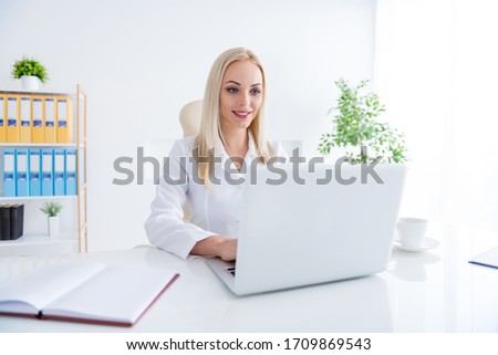 Portrait of her she nice-looking attractive cheerful focused skilled experienced girl doc writing disease illness sick leave history on laptop in modern light white work place station