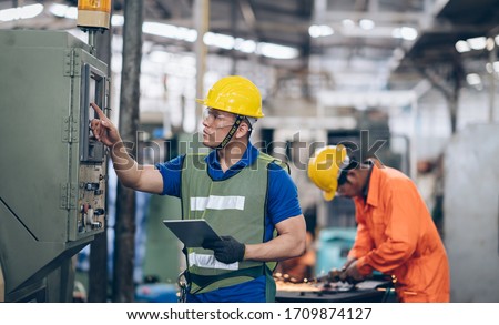 technician engineer control buttom to machinery in factory Royalty-Free Stock Photo #1709874127