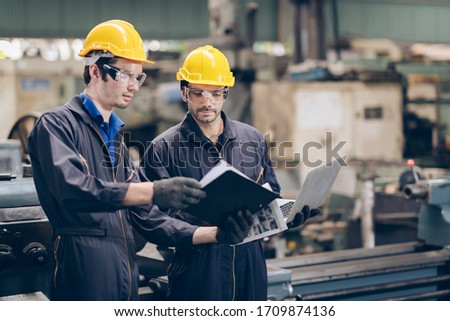 technician engineer working on paper document in factory Royalty-Free Stock Photo #1709874136