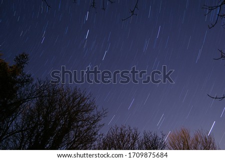 Star trails on blue sky