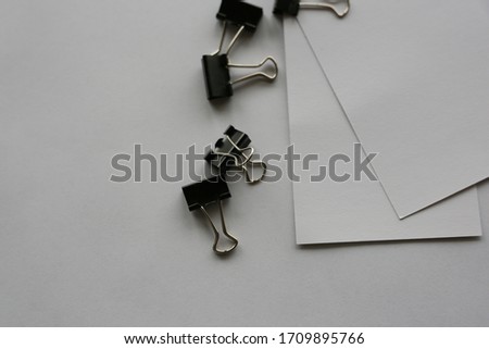 paper beside office supplies paper clips