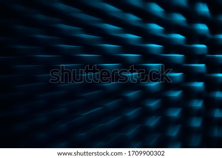 pattern of abstract blue squares growing in the dark background