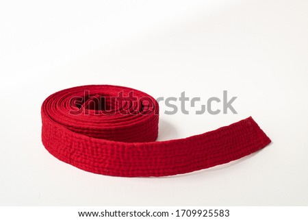 Zen art. red belt martial arts on white background. Clothes for martial arts, aikido, karate, judo. Copy paste. Royalty-Free Stock Photo #1709925583