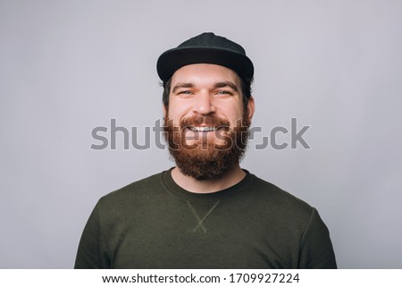portrait of handsome smiling bearded man and looking confident at the camera Royalty-Free Stock Photo #1709927224