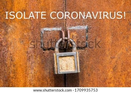 Warning on the importance of isolation, fencing and protection against Coronavirus and Covid-19. A padlock that closes a rusty metal gate symbolizes the isolation of the disease from humans.