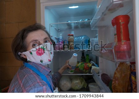 Woman stocking fresh products for quarantine. Coronavirus global pandemic. Human panic. Coronavirus quarantine.Time for self isolation.Eating, people and diet concept.Man puts vegatable in the fridge

